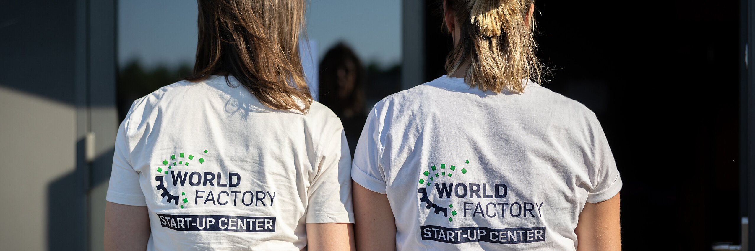 startup consulting Two women with the WSC logo on the back of their T-shirts.